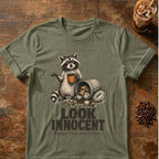 Raccoon coffee graphic for Look Innocent Raccoon on heather-military-green T-shirt