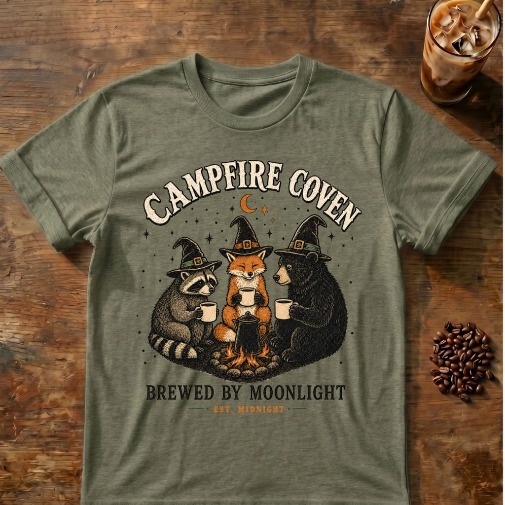 Raccoon coffee graphic for Campfire Coven Coffee on heather-military-green T-shirt