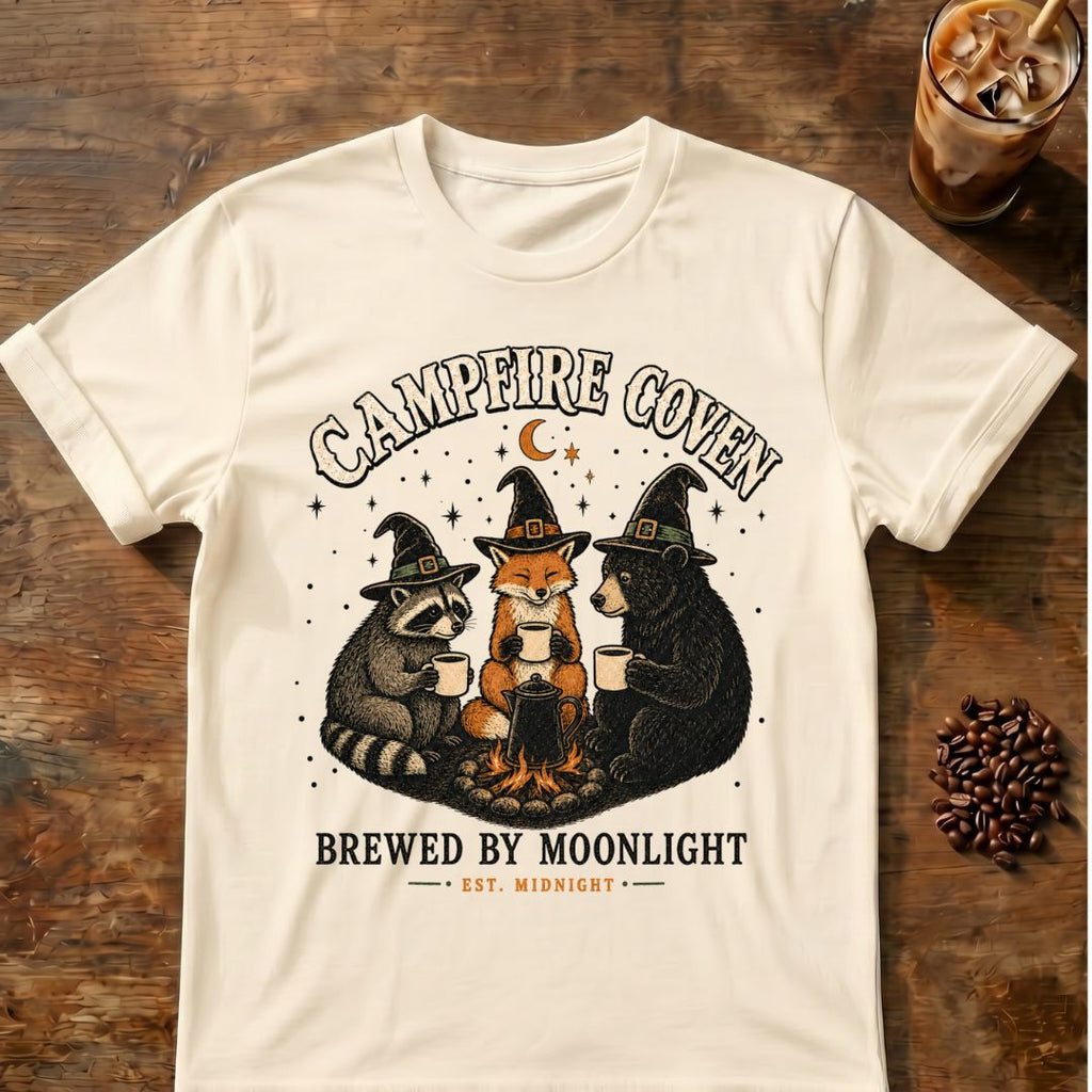 Raccoon coffee graphic for Campfire Coven Coffee on natural T-shirt