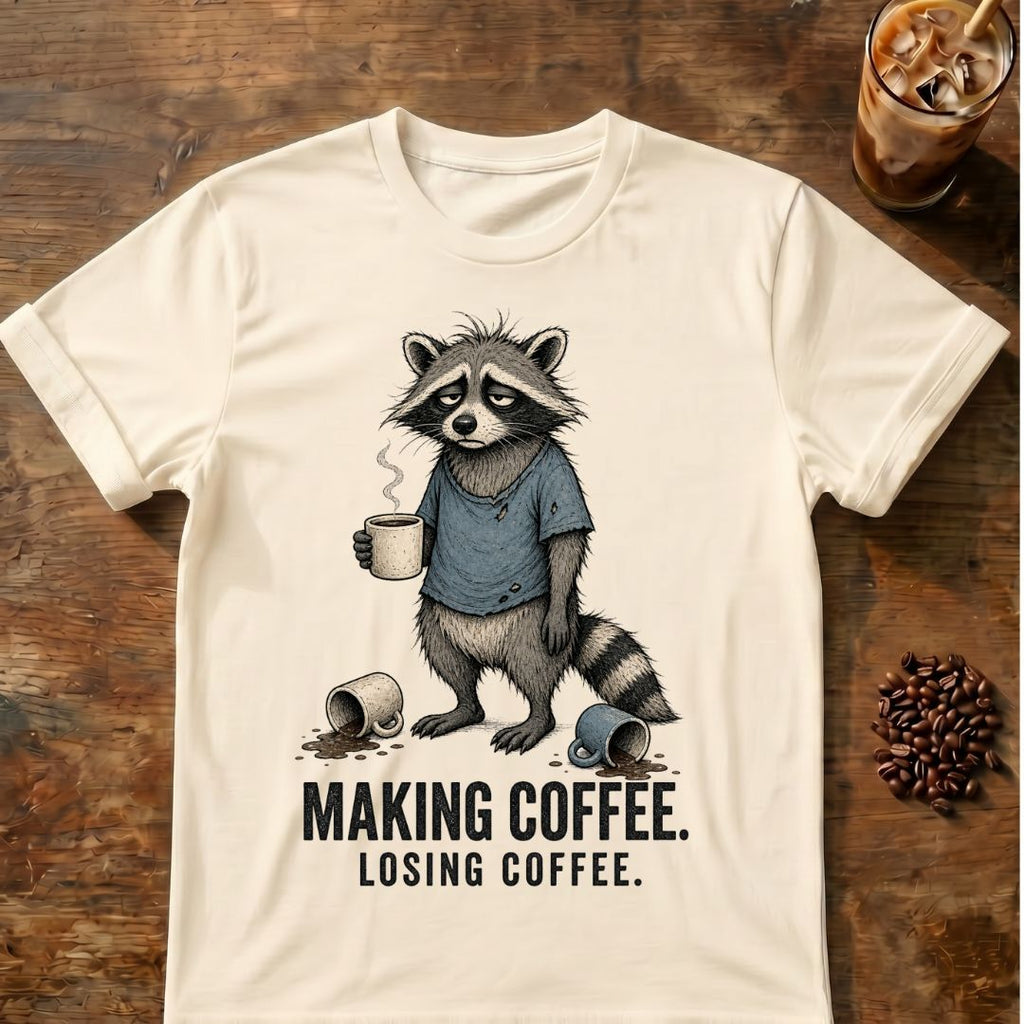 Raccoon coffee graphic on a Natural T-shirt