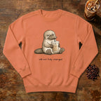 Still Not Fully Charged Platypus Sweatshirt in Terracotta, a sleepy platypus sipping iced coffee