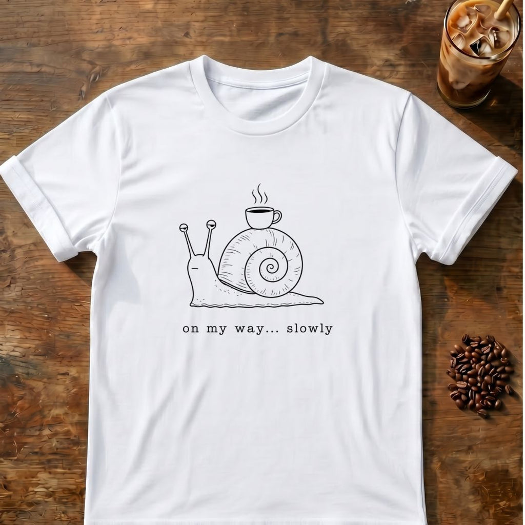 Snail carrying a steaming coffee mug on its shell with “on my way... slowly” text graphic tee