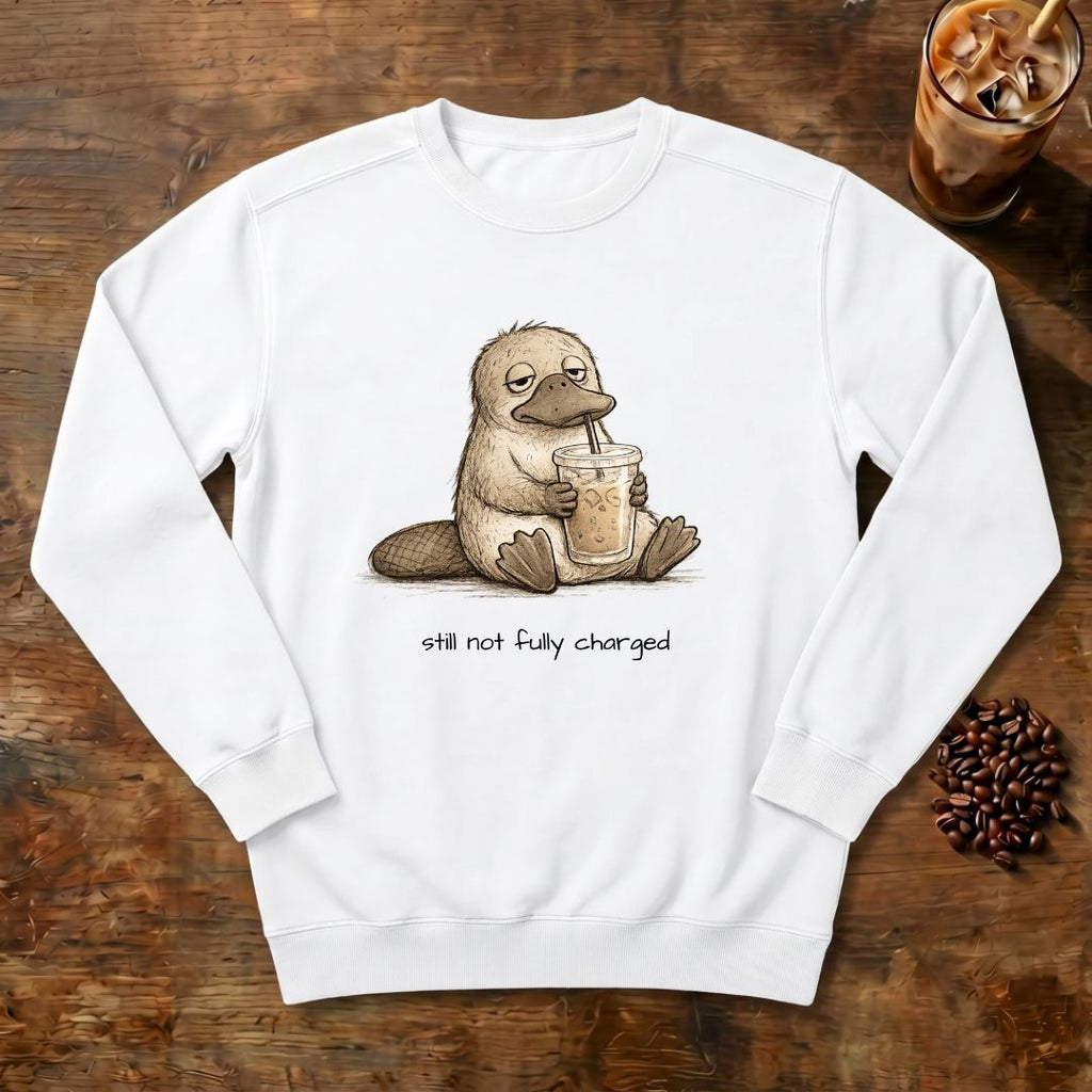 Still Not Fully Charged Platypus Sweatshirt in White, a sleepy platypus sipping iced coffee