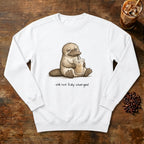 Still Not Fully Charged Platypus Sweatshirt in White, a sleepy platypus sipping iced coffee